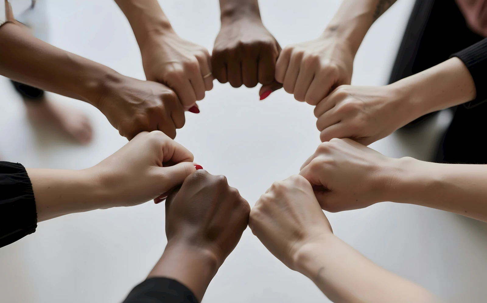 group of hands joining showing healthy relationships and care.
