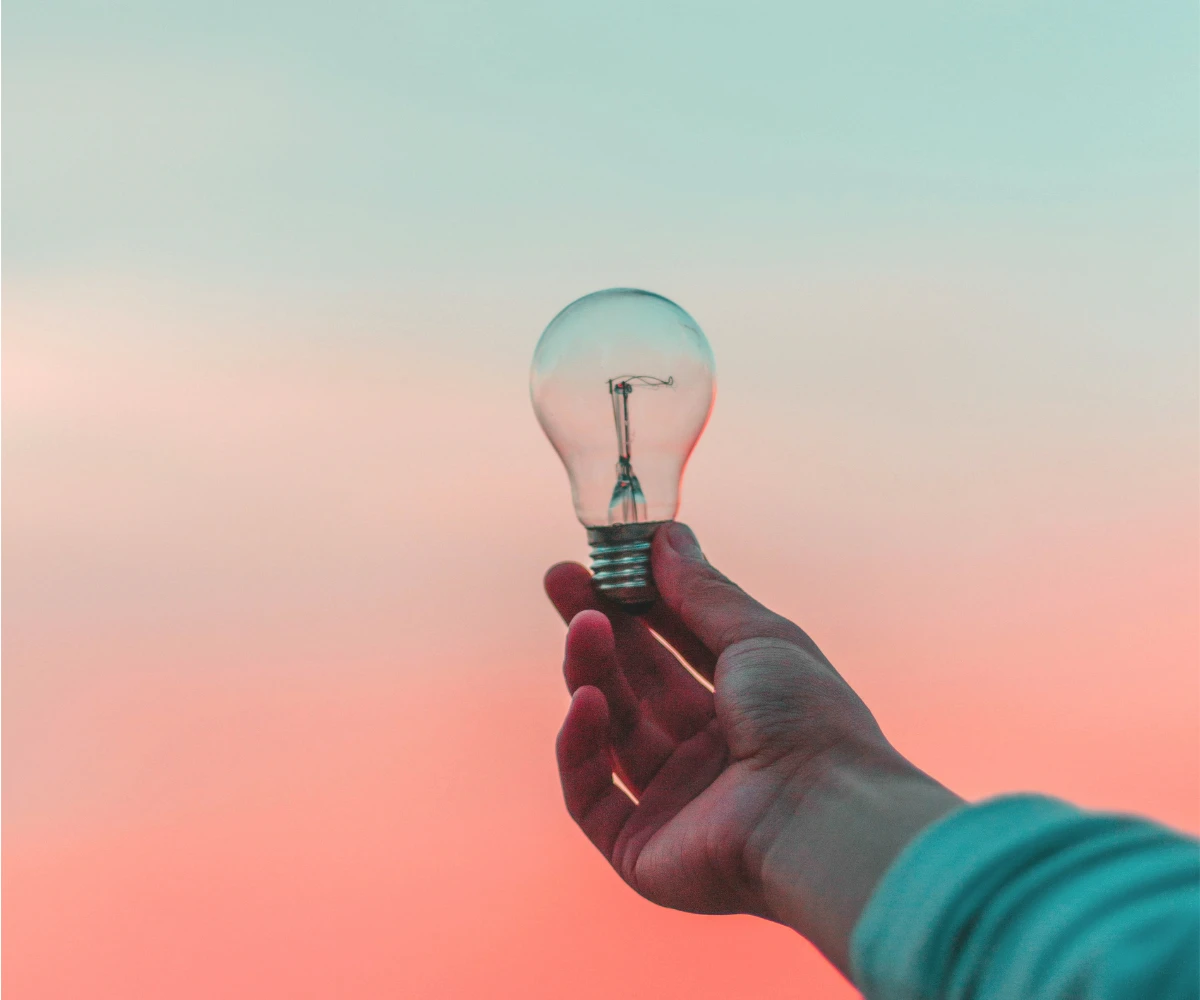Focus and Creative Thinking Person holding a glowing light bulb symbolizing creative thinking and productivity Represents productivity, creativity, problem solving and learning new skills.